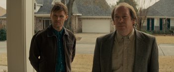 Movie still from “Midnight Special” (2016), directed by Jeff Nichols – Two men standing next to each other in front of a house; Medium shot, Over the shoulder angle