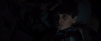 Movie still from “Midnight Special” (2016), directed by Jeff Nichols – A young boy with headphones looking at the camera; Close Up shot, High angle