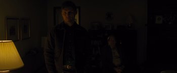 Movie still from “Midnight Special” (2016), directed by Jeff Nichols – A man standing in a dark room next to an older man; Medium shot, Over the shoulder angle