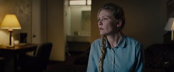 Movie still from “Midnight Special” (2016), directed by Jeff Nichols – A woman with long blonde plaits looking into the distance; Close Up shot, Over the shoulder angle