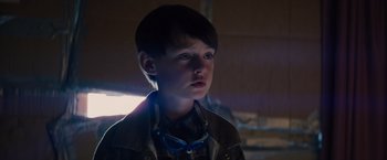 Movie still from “Midnight Special” (2016), directed by Jeff Nichols – A young boy wearing glasses looking at the camera; Close Up shot, Low angle