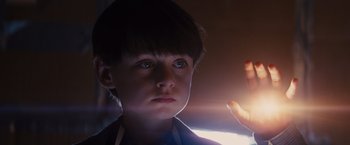 Movie still from “Midnight Special” (2016), directed by Jeff Nichols – A young boy looking at the camera while holding a cell phone; Close Up shot, Low angle