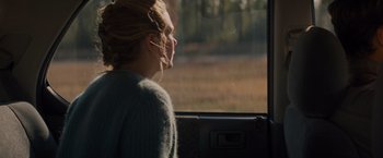 Movie still from “Midnight Special” (2016), directed by Jeff Nichols – A woman sitting in a car looking out the window; Medium shot, Over the shoulder angle