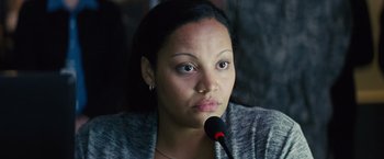 Movie still from “Midnight Special” (2016), directed by Jeff Nichols – A woman is sitting in front of a microphone; Close Up shot, High angle