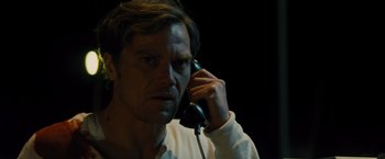 Movie still from “Midnight Special” (2016), directed by Jeff Nichols – A man on the phone in a dark room; Close Up shot, High angle