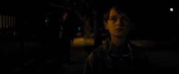 Movie still from “Midnight Special” (2016), directed by Jeff Nichols – A young boy standing in the dark at night; Close Up shot, Over the shoulder angle