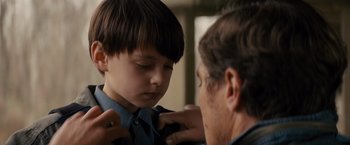 Movie still from “Midnight Special” (2016), directed by Jeff Nichols – A man helping a boy with a tie; Close Up shot, Over the shoulder angle
