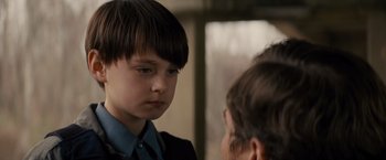 Movie still from “Midnight Special” (2016), directed by Jeff Nichols – A young boy is looking at a younger person; Close Up shot, Over the shoulder angle