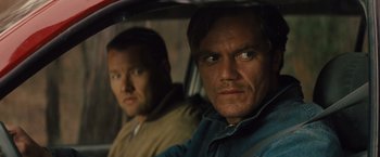Movie still from “Midnight Special” (2016), directed by Jeff Nichols – Two men in the back seat of a car looking at the camera; Close Up shot, Over the shoulder angle