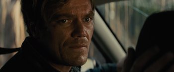 Movie still from “Midnight Special” (2016), directed by Jeff Nichols – A man's face as he drives a car; Close Up shot, Over the shoulder angle