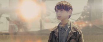 Movie still from “Midnight Special” (2016), directed by Jeff Nichols – A young boy standing in front of a window; Close Up shot, Low angle