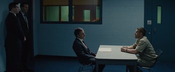 Movie still from “Midnight Special” (2016), directed by Jeff Nichols – A man sitting at a table in front of a window; Wide shot, Over the shoulder angle