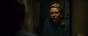 Movie still from “Midnight Special” (2016), directed by Jeff Nichols – A woman looking into a mirror in a room; Close Up shot, Over the shoulder angle