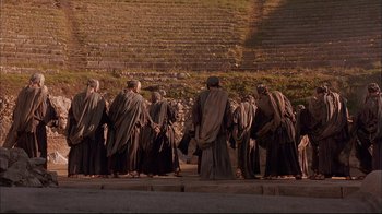 Movie still from “Mighty Aphrodite” (1995), directed by Woody Allen – A group of people standing in front of an outdoor stage; Extreme Wide shot, High angle