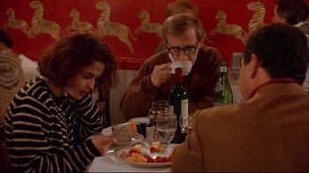 Movie still from “Mighty Aphrodite” (1995), directed by Woody Allen – A man and a woman sitting at a dinner table; Medium shot, Over the shoulder angle