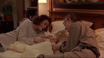 Movie still from “Mighty Aphrodite” (1995), directed by Woody Allen – A man and a woman laying in a bed together; Medium shot, High angle