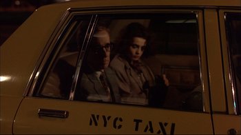 Movie still from “Mighty Aphrodite” (1995), directed by Woody Allen – A man and a woman sitting in the back seat of a taxi; Close Up shot, Low angle