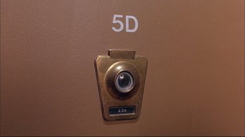 Movie still from “Mighty Aphrodite” (1995), directed by Woody Allen – The door handle of a building; Extreme Close Up shot, Overhead angle