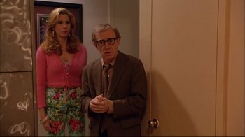 Movie still from “Mighty Aphrodite” (1995), directed by Woody Allen – A man and a woman standing next to each other in front of a door; Medium shot, Over the shoulder angle