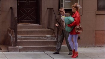 Movie still from “Mighty Aphrodite” (1995), directed by Woody Allen – A man and a woman walking down the sidewalk; Wide shot, Over the shoulder angle