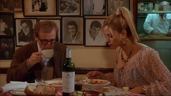 Movie still from “Mighty Aphrodite” (1995), directed by Woody Allen – A man and a woman sitting at a dinner table; Medium shot, Over the shoulder angle