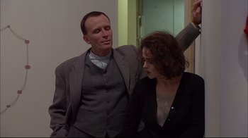 Movie still from “Mighty Aphrodite” (1995), directed by Woody Allen – A man and a woman standing next to each other; Medium shot, Low angle