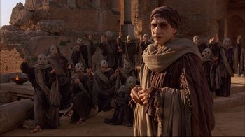 Movie still from “Mighty Aphrodite” (1995), directed by Woody Allen – A group of people dressed in medieval clothing; Medium shot, Low angle