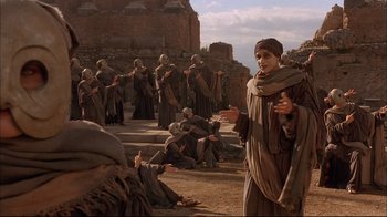 Movie still from “Mighty Aphrodite” (1995), directed by Woody Allen – A group of people dressed in ancient roman clothing; Wide shot, Over the shoulder angle