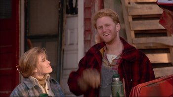 Movie still from “Mighty Aphrodite” (1995), directed by Woody Allen – A man and a woman are laughing together outside; Medium shot, Low angle