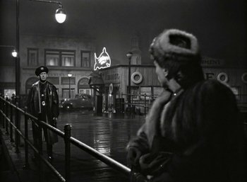 Movie still from “Mildred Pierce” (1945), directed by Michael Curtiz – A man and a woman standing on a sidewalk; Wide shot, Over the shoulder angle