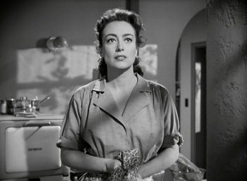 Movie still from “Mildred Pierce” (1945), directed by Michael Curtiz – An old photo of a woman in a kitchen; Close Up shot, Over the shoulder angle