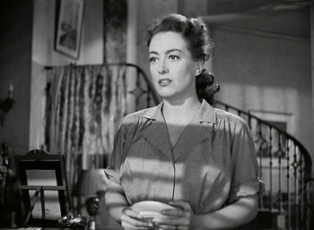 Movie still from “Mildred Pierce” (1945), directed by Michael Curtiz – An old black and white photo of a woman holding a coffee cup; Medium shot, Over the shoulder angle