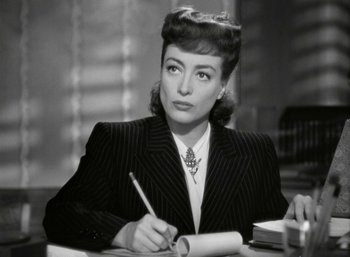 Movie still from “Mildred Pierce” (1945), directed by Michael Curtiz – An old photo of a woman writing on a piece of paper; Close Up shot, High angle