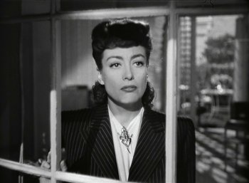 Movie still from “Mildred Pierce” (1945), directed by Michael Curtiz – An old photo of a woman looking out a window; Close Up shot, Over the shoulder angle