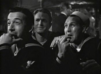 Movie still from “Mildred Pierce” (1945), directed by Michael Curtiz – A group of men standing next to each other in a room; Medium shot, Low angle