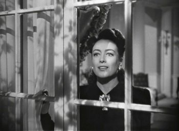 Movie still from “Mildred Pierce” (1945), directed by Michael Curtiz – An old black and white photo of a woman looking out of a window; Close Up shot, Over the shoulder angle