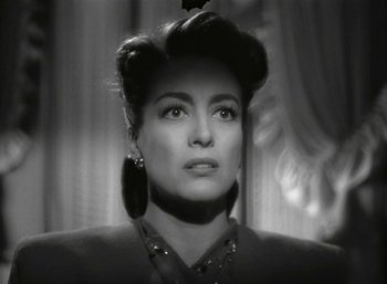 Movie still from “Mildred Pierce” (1945), directed by Michael Curtiz – A black and white photo of a woman in a black dress; Close Up shot, Over the shoulder angle