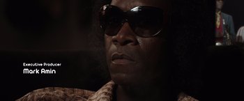 Movie still from “Miles Ahead” (2015), directed by Don Cheadle – A person wearing sunglasses; Close Up shot, Low angle