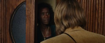 Movie still from “Miles Ahead” (2015), directed by Don Cheadle – A man looking into a mirror while standing next to a woman; Close Up shot, Over the shoulder angle