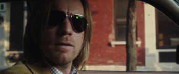 Movie still from “Miles Ahead” (2015), directed by Don Cheadle – A person wearing sunglasses; Close Up shot, Over the shoulder angle
