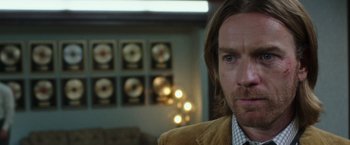 Movie still from “Miles Ahead” (2015), directed by Don Cheadle – A person wearing a jacket; Close Up shot, Over the shoulder angle