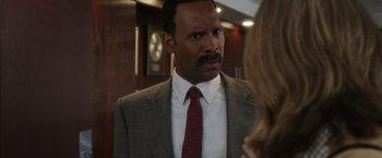 Movie still from “Miles Ahead” (2015), directed by Don Cheadle – A man wearing a suit and tie talking to a woman; Close Up shot, Over the shoulder angle