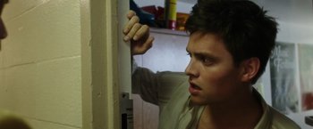 Movie still from “Miles Ahead” (2015), directed by Don Cheadle – A young man looking into a mirror in a room; Close Up shot, Low angle