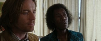 Movie still from “Miles Ahead” (2015), directed by Don Cheadle – Two men are looking at each other in a room; Close Up shot, Over the shoulder angle