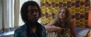 Movie still from “Miles Ahead” (2015), directed by Don Cheadle – A man and a woman sitting next to each other in a room; Close Up shot, Low angle