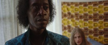 Movie still from “Miles Ahead” (2015), directed by Don Cheadle – A person wearing a suit and tie; Close Up shot, Over the shoulder angle