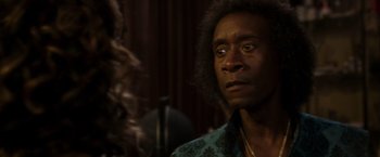 Movie still from “Miles Ahead” (2015), directed by Don Cheadle – A person wearing a blue shirt; Close Up shot, Over the shoulder angle