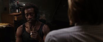 Movie still from “Miles Ahead” (2015), directed by Don Cheadle – A man smoking a cigarette in front of a mirror; Close Up shot, Over the shoulder angle