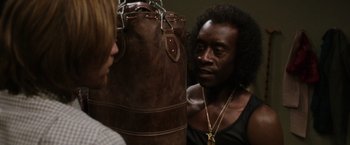 Movie still from “Miles Ahead” (2015), directed by Don Cheadle – A man in a black shirt is talking to a woman; Close Up shot, Over the shoulder angle