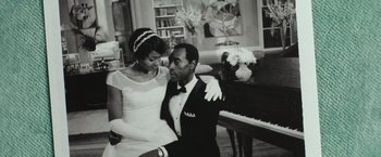 Movie still from “Miles Ahead” (2015), directed by Don Cheadle – A man and a woman sitting in front of a grand piano; Medium shot, Low angle